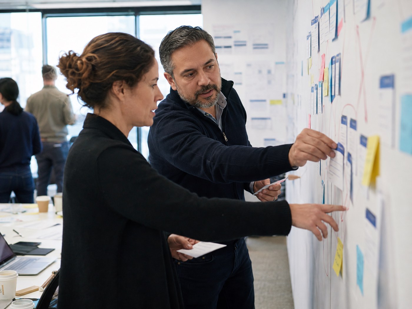 Operations leaders tracing process bottlenecks on a workshop wall